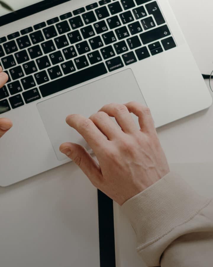hand typing on laptop